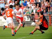 23 July 2011; Tommy McGuigan, Tyrone, shoots to score his side's second goal past Armagh goalkeeper Paul Hearty. GAA Football All-Ireland Senior Championship Qualifier Round 3. Tyrone v Armagh, Healy Park, Omagh, Co. Tyrone. Picture credit: Michael Cullen / SPORTSFILE