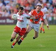 23 July 2011; Brian McGuigan, Tyrone, in action against Ciaran McKeever, Armagh. GAA Football All-Ireland Senior Championship Qualifier Round 3. Tyrone v Armagh, Healy Park, Omagh, Co. Tyrone. Picture credit: Michael Cullen / SPORTSFILE