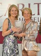 25 July 2011; Ailish O'Donoghue, owner of Fosters Cross, right, is presented with the trophy by Siobhan Burke, general manager of the Carlton Hotel, Galway, after winning the carlton.ie/galwaycity (Q.R.) Handicap. Galway Racing Festival 2011, Ballybrit, Galway. Picture credit: Diarmuid Greene / SPORTSFILE