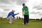 26 July 2011; Special Olympics Ireland athlete Stephen Deignan, Blainroe, Co. Wicklow, who finished 5th in his golfing competition (level 4) at the 2011 Special Olympics World Games in Athens, receives some putting tips from three time Major Champion and Special Olympics Global Ambassador Padraig Harrington who has announced that he will Wear the Laces for Special Olympics in his bid to recapture the Irish Open Championship at the Killarney Golf & Fishing Club from July 28th to July 31st. Wear the Laces is a fundraising and awareness campaign that calls on fans to wear distinctive Special Olympics emblazoned shoelaces to promote respect, acceptance and inclusion for people with intellectual disabilities. For more information visit www.specialolympics.org/wearthelaces or contact Colin Kenny at 01 6755718. Picture credit: Matt Browne / SPORTSFILE