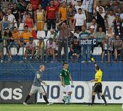 26 July 2011; Referee Artyom Kuchin issues Anthony O'Connor, Republic of Ireland, with a yellow card, as goalkeeper Aaron McCarey protests. 2010/11 UEFA European Under-19 Championship - Group A, Republic of Ireland v Romania, City Stadium, Berceni, Bucharest, Romania. Picture credit: Stephen McCarthy / SPORTSFILE