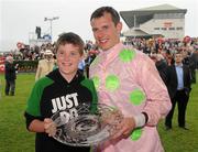 27 July 2011; Jockey Paul Townend with Daniel Broderick, aged 10, from Castlegar, Co. Galway, after winning the www.thetote.com Galway Plate (Steeplechase Handicap) (Grade A) with Blazing Tempo. Galway Racing Festival 2011, Ballybrit, Galway. Picture credit: Diarmuid Greene / SPORTSFILE