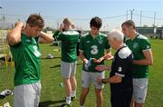 28 July 2011; Republic of Ireland players, from left, Jeff Hendrick, Aaron McCarey, Joe Shaughnessy, Kevin Knight and assistant coach Tommy Connolly apply sun cream before squad training ahead of their side's 2010/11 UEFA European Under-19 Championship Semi-Final, on Friday, against Spain. 2010/11 UEFA European Under-19 Championship, Concordia Stadium, Chiajna, Bucharest, Romania. Picture credit: Stephen McCarthy / SPORTSFILE