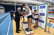 19 February 2017; Irish Olympic gold medallist at the 1956 Olympics, Ronnie Delany, presents Cillian Kirwan, Raheny Shamrocks AC, Co Dublin, with his bronze medal after the Men's 1500m Final during the Irish Life Health National Senior Indoor Championships at the Sport Ireland National Indoor Arena in Abbotstown, Dublin. Photo by Brendan Moran/Sportsfile