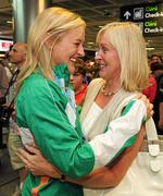 30 July 2011; Ireland's Sarah Lavin, Emerald AC, Co. Limerick, who won a Bronze medal in the 100 metres hurdles, is welcomed home by her mother Emily on her arrival at Dublin Airport as the Irish team return from the European Youth Olympics in Turkey. Dublin Airport, Dublin. Picture credit: Ray McManus / SPORTSFILE