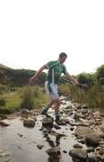 30 July 2011; Tipperary's Brendan Cummins crosses the river during the Poc Fada na hÉireann. Annaverna Mountains, Dundalk, Co. Louth. Picture credit: Ray Lohan / SPORTSFILE