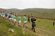 30 July 2011; Patrick Martin leads the procession playing the bag pipes before start of the Poc Fada na hÉireann. Annaverna Mountains, Dundalk, Co. Louth. Picture credit: Ray Lohan / SPORTSFILE