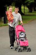 31 July 2011; Alan Murphy and 15 month old Zara, from Ballyfermot, Dublin, before the start of the Athletics Ireland Family Fitness Festival at Farmleigh. Phoenix Park, Dublin. Picture credit: Ray McManus / SPORTSFILE