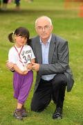 31 July 2011; Three year old Victorine Tám Thomas, from Clondalkin, Dublin, with Liam Hennessy, President of Athletics Ireland, after finishing the Athletics Ireland Family Fitness Festival at Farmleigh. Phoenix Park, Dublin. Picture credit: Ray McManus / SPORTSFILE