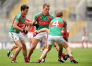 31 July 2011; Pearse O'Neill, Cork, is tackled by Mayo players from left, Ger Cafferkey, Aidan O'Shea and Tom Cunniffe. GAA Football All-Ireland Senior Championship Quarter-Final, Mayo v Cork, Croke Park, Dublin. Picture credit: Oliver McVeigh / SPORTSFILE