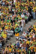 30 July 2011; Donegal piper Christy Murray, from Raphoe,  arrives to take his seat with a group of Donegal supporters. GAA Football All-Ireland Senior Championship Quarter-Final, Donegal v Kildare, Croke Park, Dublin. Picture credit: Ray McManus / SPORTSFILEFILE