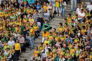 30 July 2011; Donegal piper Christy Murray, from Raphoe,  arrives to take his seat with a group of Donegal supporters. GAA Football All-Ireland Senior Championship Quarter-Final, Donegal v Kildare, Croke Park, Dublin. Picture credit: Ray McManus / SPORTSFILE
