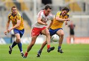 30 July 2011; Kyle Coney, Tyrone, in action against Sean McDermott and Senan O'Grady, Roscommon. GAA Football All-Ireland Senior Championship Qualifier, Round 4, Roscommon v Tyrone, Croke Park, Dublin. Picture credit: Oliver McVeigh / SPORTSFILE