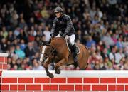 6 August 2011; Rene Tebbel, Germany, competing on Mats' Up Du Plessis, clears the &quot;Wall&quot; to win the Land Rover Puissance. Dublin Horse Show 2011. RDS, Ballsbridge, Dublin. Picture credit: Barry Cregg / SPORTSFILE