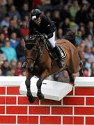 6 August 2011; Conor Swail, Ireland, competing on Vicar, fails to clear the &quot;Wall&quot; in the jump off during the Land Rover Puissance. Dublin Horse Show 2011. RDS, Ballsbridge, Dublin. Picture credit: Barry Cregg / SPORTSFILE