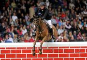 6 August 2011; Alex Duffy, Ireland, competing on Mountain King, clears the &quot;Wall&quot; in the first round during the Puissance. Dublin Horse Show 2011. RDS, Ballsbridge, Dublin. Picture credit: Barry Cregg / SPORTSFILE