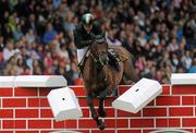 6 August 2011; Cian O'Connor, Ireland, competing on On Ira, fails to clear the &quot;Wall&quot; in the jump off during the Land Rover Puissance. Dublin Horse Show 2011. RDS, Ballsbridge, Dublin. Picture credit: Barry Cregg / SPORTSFILE