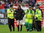 6 August 2011; Dave Quigley, Ireland, is tended to by medical personnel after being thrown from his mount, Valetto Jx, as he attempted to clear the &quot;Wall&quot; during the Land Rover Puissance. Dublin Horse Show 2011. RDS, Ballsbridge, Dublin. Picture credit: Barry Cregg / SPORTSFILE