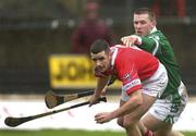 25 February 2002; Mark Prendergast of Cork in action against Mark Foley of Limerick during the Allianz National Hurling League Division 1B Round 1 match between Limerick and Cork at the Gaelic Grounds in Limerick. Photo by Brendan Moran/Sportsfile