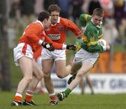24 March 2002; Marc O'Se of Kerry in action against Oisin McConville, left, and Kieran McGeeney of Armagh during the Allianz National Football League Division 2A Round 6 match between Kerry and Armagh at Austin Stack Park in Tralee, Kerry. Photo by Brendan Moran/Sportsfile