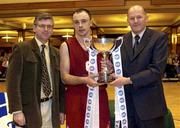 24 March 2002; Tralee captain John Teahan is presented with the trophy by President of the IBA, Tony Colgan, right, following the ESB Men's National Championships Final between Frosties Tigers Tralee and Dart Killester at the National Exhibition Centre in Killarney, Kerry. Photo by Brendan Moran/Sportsfile