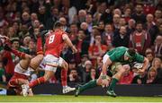 10 March 2017; CJ Stander of Ireland evades the tackle of Leigh Halfpenny and Rhys Webb, 9, of Wales during the RBS Six Nations Rugby Championship match between Wales and Ireland at the Principality Stadium in Cardiff, Wales. Photo by Stephen McCarthy/Sportsfile