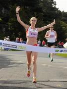 20 August 2011; Gemma Marie Steel, from England, crosses the finish line to win the Women's Frank Duffy 10 Mile race, Phoenix Park, Dublin. Picture credit: Pat Murphy / SPORTSFILE
