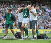 20 August 2011; Felix Jones, Ireland, is assissted to a medical cart to be removed with an injury by team doctor, Dr. Eanna Falvey, and Dave Revins, right. Rugby World Cup Warm-up game, Ireland v France, Aviva Stadium, Lansdowne Road, Dublin. Picture credit: Brendan Moran / SPORTSFILE