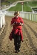 14 March 2017; Groom Karolina Dynavowska, who is in charge of the John Hanlon-trained Magna Carta in the first race reads the form as she returns to the stables ahead of the races during the Cheltenham Racing Festival at Prestbury Park, in Cheltenham, England. Photo by Cody Glenn/Sportsfile