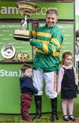 14 March 2017; Jockey Noel Fehily with his son Michael, age 2, and daughter Niamh, age 4, after winning the Stan James Champion Hurdle Challenge Trophy on Buveur D'Air during the Cheltenham Racing Festival at Prestbury Park, in Cheltenham, England. Photo by Seb Daly/Sportsfile
