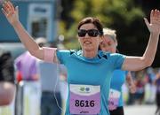 20 August 2011; Catherine Clarke, Dublin, celebrates as she crosses the finish line at the National Lottery Frank Duffy 10 Mile race, Phoenix Park, Dublin. Picture credit: Conor O Beolain / SPORTSFILE
