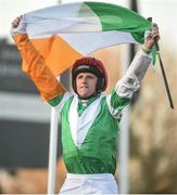 15 March 2017; Jamie Codd celebrates with the tricolour as he enters the winner's enclosure after winning the Weatherbys Champion Bumper on Fayonagh during the Cheltenham Racing Festival at Prestbury Park in Cheltenham, England. Photo by Cody Glenn/Sportsfile