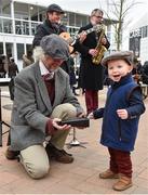 16 March 2017; Harry Almond, age 2, from Thirsk, England, playes the cow bell with the &quot;Hipcats&quot; comprised of, from left, David Mowat, Paul Mahon, and Kevin Figes prior to the races during the Cheltenham Racing Festival at Prestbury Park in Cheltenham, England. Photo by Cody Glenn/Sportsfile