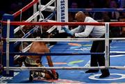 18 March 2017; Roman Gonzalez recovers from a first round knock down by Srisaket Sor Rungvisai during their super flyweight title bout at Madison Square Garden in New York, USA. Photo by Ramsey Cardy/Sportsfile