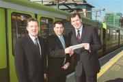 28 March 2001; Irish soccer hero Packie Bonner, in the company of Michael Murphy, left, Manager DART Suburban, right,  today presented Brian Treacy, a DART commuter from Bray with a trip for two to Ireland's World Cup matches in Japan in June. Brian won the prize having purchased an annual DART/Suburban rail ticket under the Easi-Travel Plan, which was entered in the DART/Suburban rail prepaid ticket draw for the prize, which includes €2,002 spending money. Photo by Ray McManus/Sportsfile