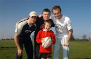28 March 2002; Ireland rugby players from, from left, Girvan Dempsey, Brian O'Driscoll and Denis Hickie with Conor McLoughlin, age 9, from Limerick, at the Reebok Rugby training session held by the three players at UCD in Dublin. Photo by Aoife Rice/Sportsfile