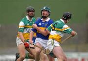 30 March 2002; David Kennedy of Tipperary in action against Hubert Rigney, 6, and Gary Hannify of Offaly during the Allianz National Hurling League Division 1B Round 1 match between Offaly and Tipperary in St Brendan's Park in Birr, Offaly. Photo by Brendan Moran/Sportsfile