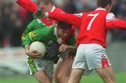 31 March 2002; Fionnan Kelliher of Kerry is tackled by Aaron Hoey and Peter McGinnity, 7, of Louth during the Allianz National Football League Division 2A Round 7 match between Louth and Kerry at Páirc Mhuire in Ardee in Louth. Photo by Aoife Rice/Sportsfile