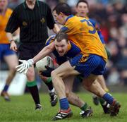 31 March 2002; Adrian Sweeney of Donegal is tackled by John Whyte of Roscommon during the Allianz Football League Division 1A Round 7 match between Roscommon and Donegal at Dr Hyde Park in Roscommon. Please note Donegal wore the Roscommon  away strip due to a clash of jerseys. Photo by Ray McManus/Sportsfile