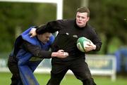 28 February 2002; Brian O'Driscoll is tackled by John Kelly  during Ireland Rugby Squad Training at Dr Hickey Park in Greystones, Wicklow. Photo by Matt Browne/Sportsfile