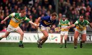 30 March 2002; Brian O'Meara of Tipperary in action against Barry Whelahan, left, and Johnny Dooley of Offaly during the Allianz National Hurling League Division 1B Round 1 match between Offaly and Tipperary in St Brendan's Park in Birr, Offaly. Photo by Brendan Moran/Sportsfile