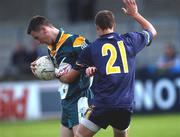 3 April 2002; Dermot McGlade of Ireland is tackled by Scott Mathieson of Australia during the U17 International Rules Second Test match between Ireland and Australia at Parnell Park in Dublin. Photo by Aoife Rice/Sportsfile