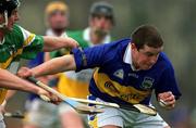 30 March 2002; John Carroll of Tipperary in action against Hubert Rigney of Offaly during the Allianz National Hurling League Division 1B Round 1 match between Offaly and Tipperary in St Brendan's Park in Birr, Offaly. Photo by Brendan Moran/Sportsfile