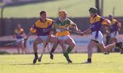 7 April 2002; Joe Erity of Offaly is tackled by Trevor Kelly, left, and David O'Brien of Wexford during the Allianz National Hurling League Division 1B Round 5 match between Offaly and Wexford at St Brendan's Park in Birr, Offaly. Photo by Aoife Rice/Sportsfile