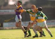 7 April 2002; David O'Brien of Wexford in action against John Paul O'Meara, 4, and Niall Claffey of Offaly during the Allianz National Hurling League Division 1B Round 5 match between Offaly and Wexford at St Brendan's Park in Birr, Offaly. Photo by Aoife Rice/Sportsfile
