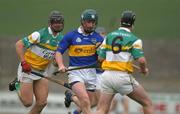 30 March 2002; David Kennedy of Tipperary in action against Hubert Rigney, 6, and Gary Hannify of Offaly during the Allianz National Hurling League Division 1B Round 1 match between Offaly and Tipperary in St Brendan's Park in Birr, Offaly. Photo by Brendan Moran/Sportsfile