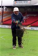 11 April 2002; Groundsman Paddy Deignam reseeds the pitch at Tolka Park in Dublin. Photo by Ray McManus/Sportsfile