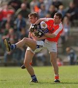 14 April 2002; Noel Garvan of Laois is tackled by Diarmuid Marsden of Armagh during the Allianz National Football League Division 2 Semi-Final match between Armagh and Laois at Pearse Park in Longford. Photo by Ray McManus/Sportsfile