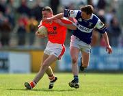 14 April 2002; John Toal of Armagh is tackled by Paul McDonald of Laois during the Allianz National Football League Division 2 Semi-Final match between Armagh and Laois at Pearse Park in Longford. Photo by Ray McManus/Sportsfile