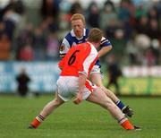 14 April 2002; Michael Lawlor of Laois in action against Francie Bellew of Armagh during the Allianz National Football League Division 2 Semi-Final match between Armagh and Laois at Pearse Park in Longford. Photo by Ray McManus/Sportsfile